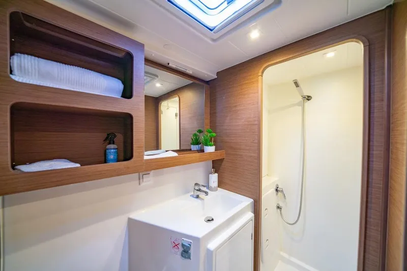 Slide: The Image of Luxurious bathroom interior of 2018 Lagoon 42 catamaran with modern fixtures and natural light. - 13
