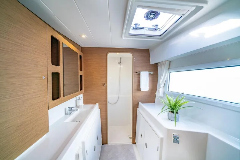 Slide: The Image of Luxurious cabin interior of 2018 Lagoon 42 catamaran with cozy bedding and natural light. - 14