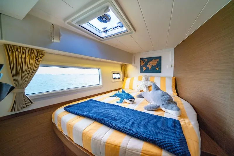 Slide: The Image of Cozy cabin interior of 2018 Lagoon 42 catamaran with plush toys and ocean view. - 16
