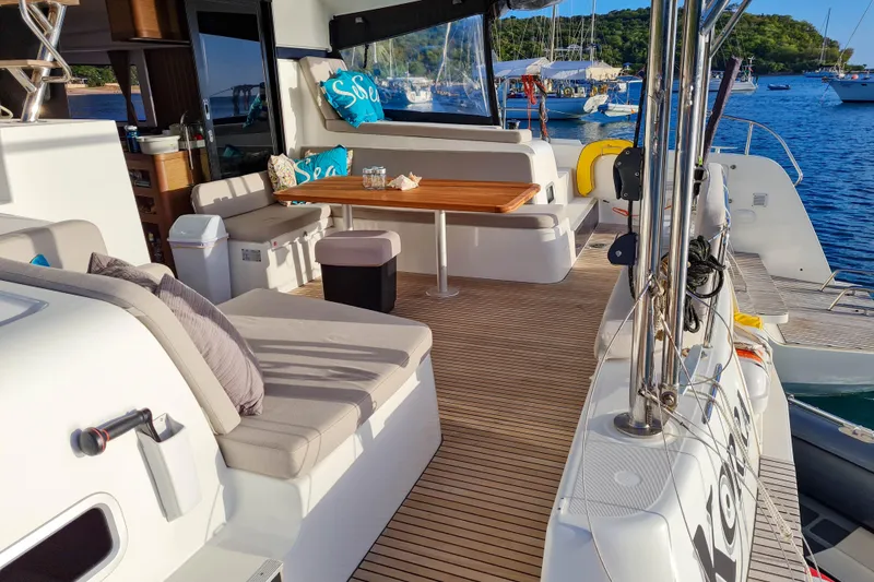 Slide: The Image of 2018 Lagoon 42 catamaran cockpit with steering wheel, navigation instruments, and ocean view. - 3