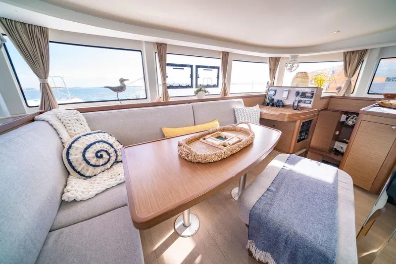 Slide: The Image of Interior of 2018 Lagoon 42 catamaran with modern navigation equipment and cozy seating area. - 5