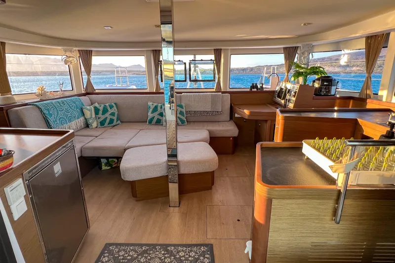 Slide: The Image of Interior of 2018 Lagoon 42 catamaran kitchen with modern amenities and wooden cabinetry. - 7