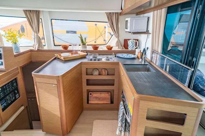 Slide: The Image of Luxurious interior of 2019 Lagoon 42 catamaran with cozy bedroom and elegant wooden furnishings. - 9
