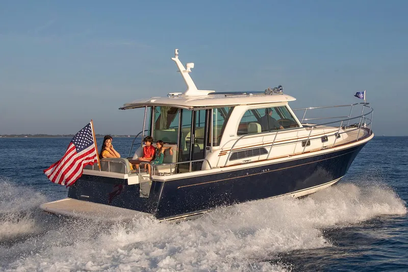 Slide: The Image of Manufacturer Provided Image: 2026 Sabre 38 Salon Express cruising with passengers, American flag waving, on open water. - 10