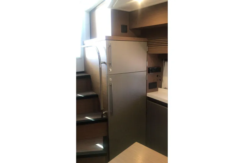 Slide: The Image of Modern kitchen area in a 2020 Beneteau Gran Turismo 46 yacht, featuring sleek cabinetry. - 22