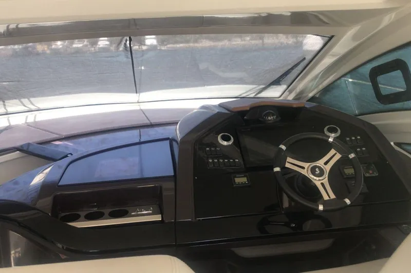 Slide: The Image of Cockpit of 2020 Beneteau Gran Turismo 46 yacht with modern steering and controls. - 23