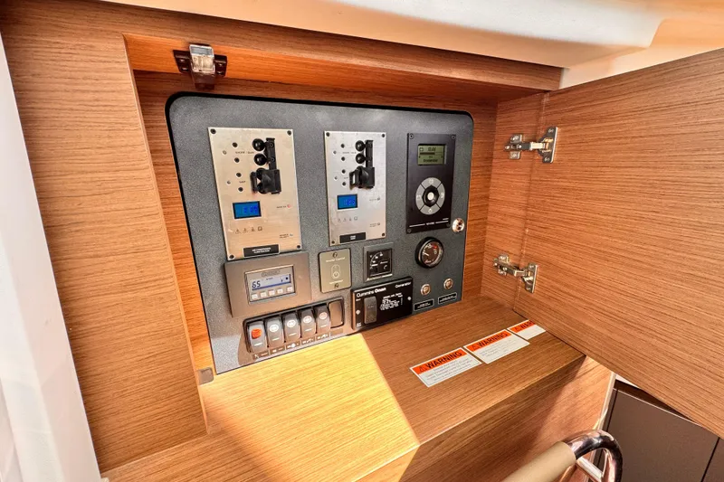 Slide: The Image of Control panel inside a 2020 Beneteau Gran Turismo 46 yacht, featuring various switches and displays. - 32