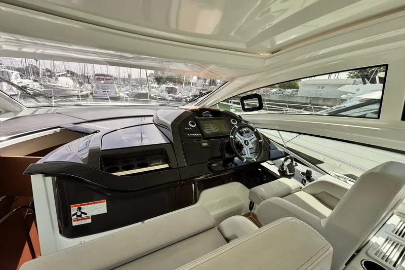Slide: The Image of Interior cockpit of 2020 Beneteau Gran Turismo 46 yacht, featuring modern controls and seating. - 33