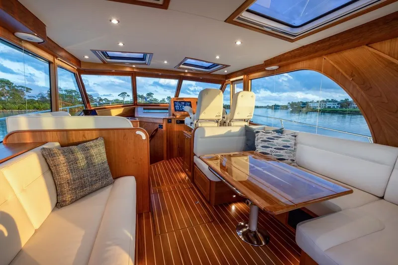 Slide: The Image of Luxurious interior of 2027 Sabre 51 Salon Express yacht with panoramic windows and elegant seating. - 3