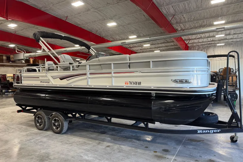The Image of 2022 Ranger 223FC pontoon boat on trailer in indoor storage facility. - 1