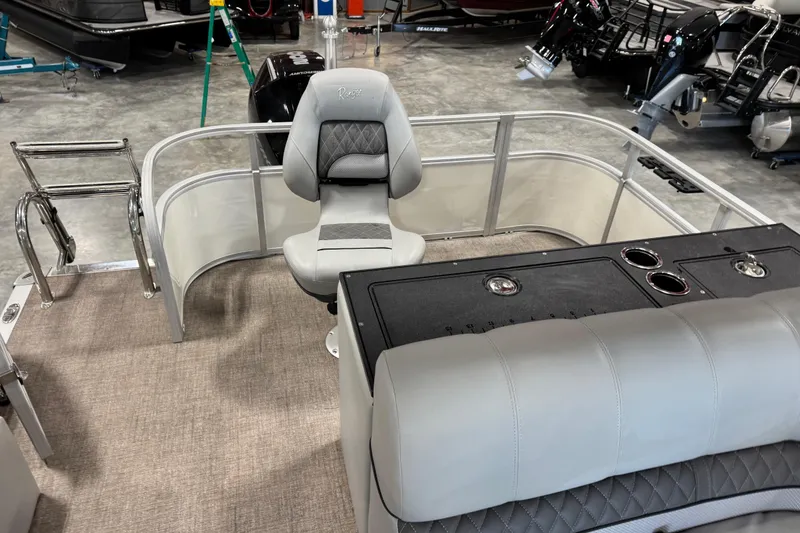 Slide: The Image of 2022 Ranger 223FC boat interior with seating and control panel in showroom. - 10