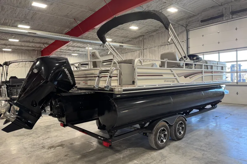 Slide: The Image of 2022 Ranger 223FC pontoon boat with Mercury outboard motor in a warehouse setting. - 3