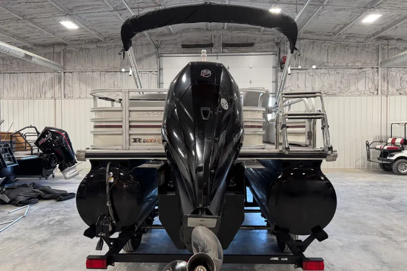 Slide: The Image of 2022 Ranger 223FC pontoon boat with outboard motor in a warehouse setting. - 4
