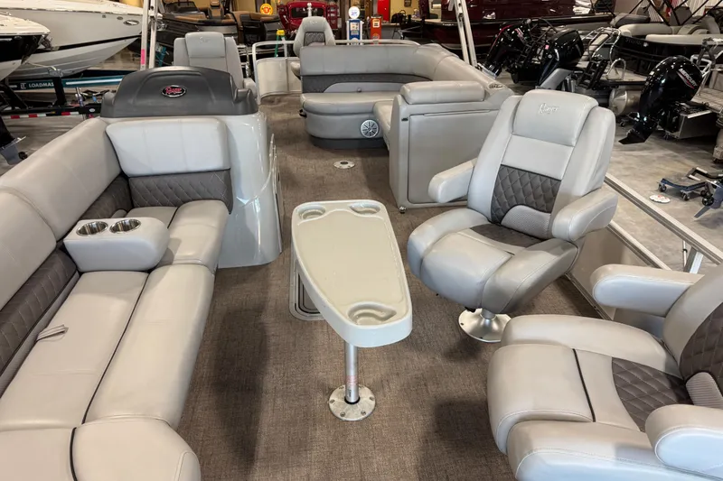 Slide: The Image of 2022 Ranger 223FC boat interior with plush seating and table setup. - 5