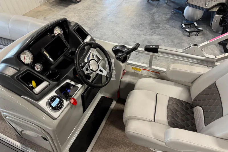 Slide: The Image of 2022 Ranger 223FC boat cockpit with steering wheel, gauges, and comfortable seating. - 7