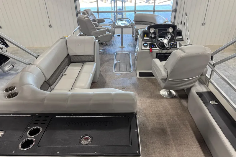 Slide: The Image of 2022 Ranger 223FC boat interior with plush seating and modern helm controls. - 8