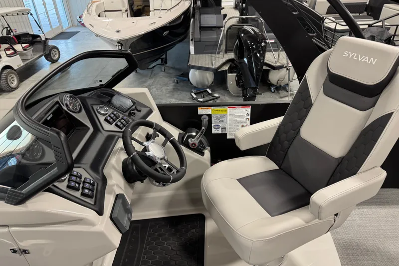 Slide: The Image of 2026 Sylvan L-5 Platinum boat interior with steering console and captain's chair. - 13