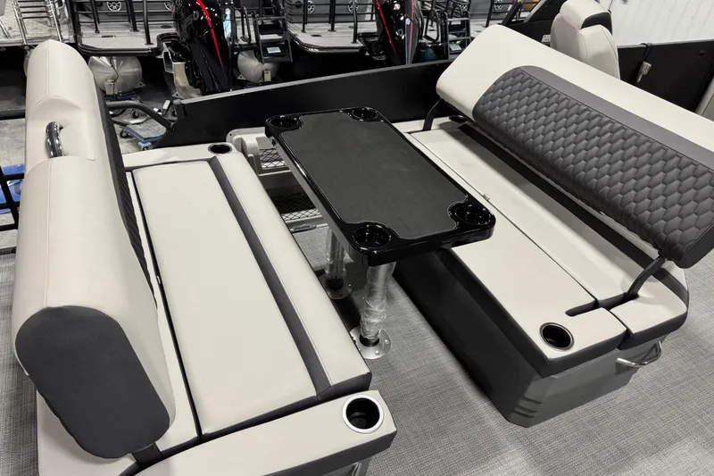 Slide: The Image of Interior seating of 2026 Sylvan L-5 Platinum boat with table and cup holders. - 14