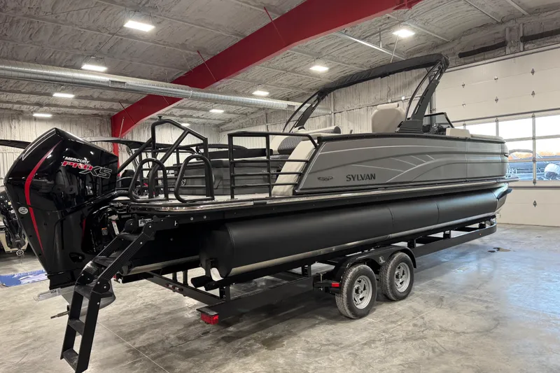 Slide: The Image of 2026 Sylvan L-5 Platinum pontoon boat on trailer in indoor showroom. - 3