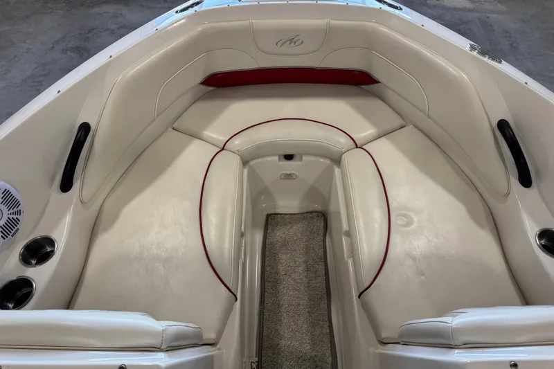 Slide: The Image of 2006 Monterey 234FS boat interior with white seating and red accents. - 10