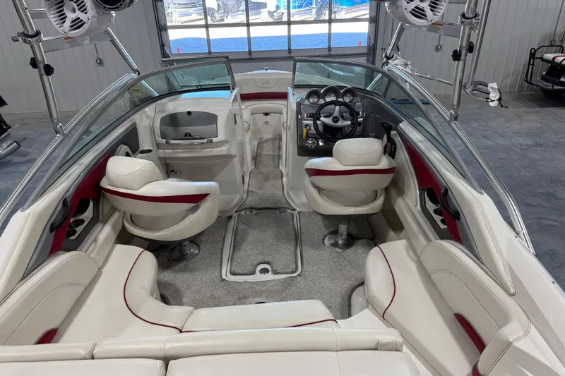 Slide: The Image of Interior of a 2006 Monterey 234FS boat with white and red seating. - 13