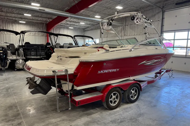 Slide: The Image of 2006 Monterey 234FS boat in a showroom, red and white design on a trailer. - 15