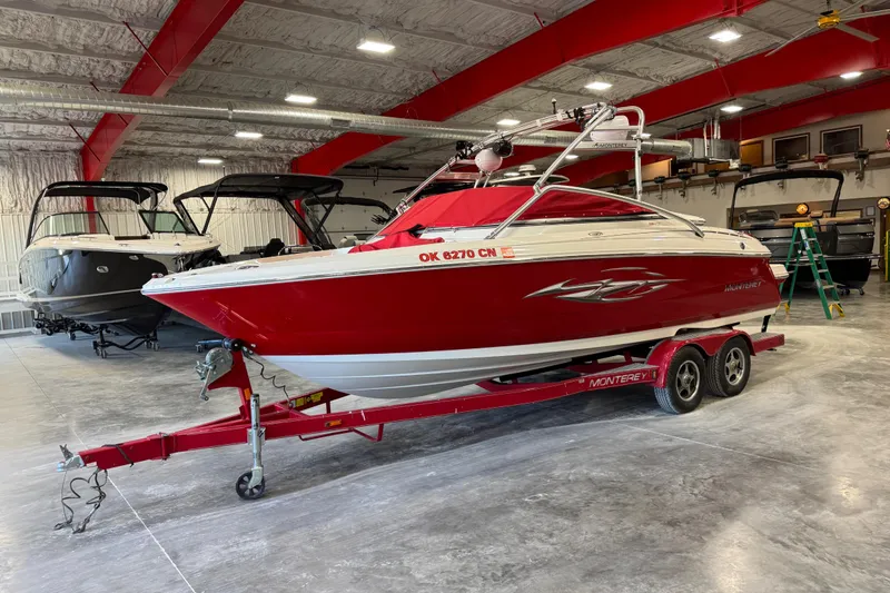 Slide: The Image of Red 2006 Monterey 234FS boat on trailer in indoor storage facility. - 16