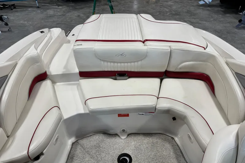 Slide: The Image of 2006 Monterey 234FS boat interior with white and red seating arrangement. - 8