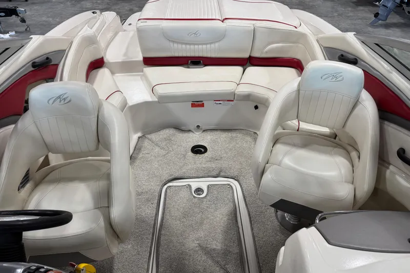Slide: The Image of Interior of a 2006 Monterey 234FS boat with white and red seating. - 9