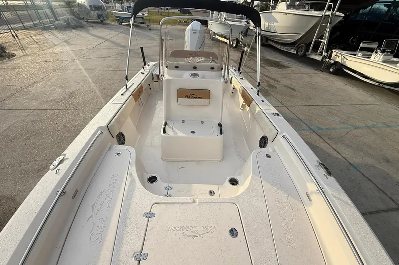 Slide: The Image of 2026 Sea Chaser 23 LX boat interior with seating and storage compartments. - 13