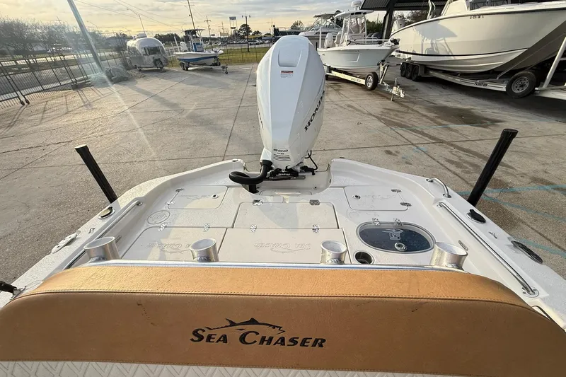 Slide: The Image of 2026 Sea Chaser 23 LX boat with Honda outboard motor in a marina setting. - 9