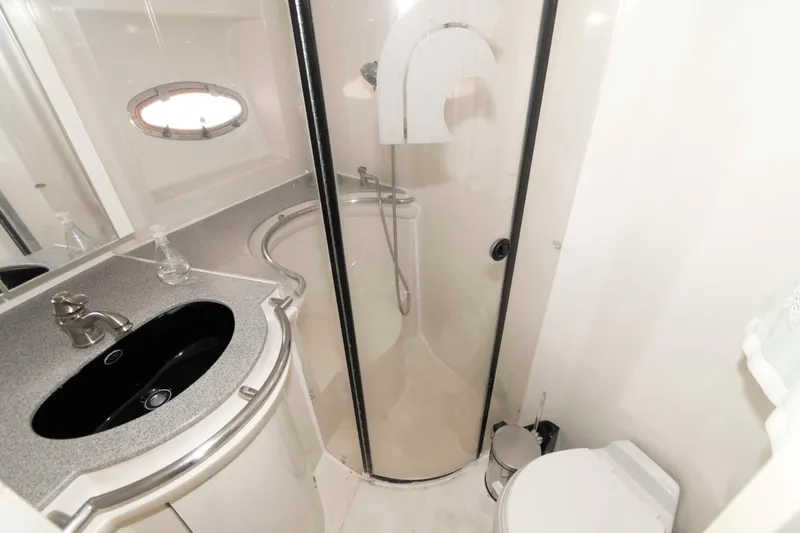 Slide: The Image of Bathroom interior of 1996 Trojan 440 Express Yacht with shower, sink, and toilet. - 18