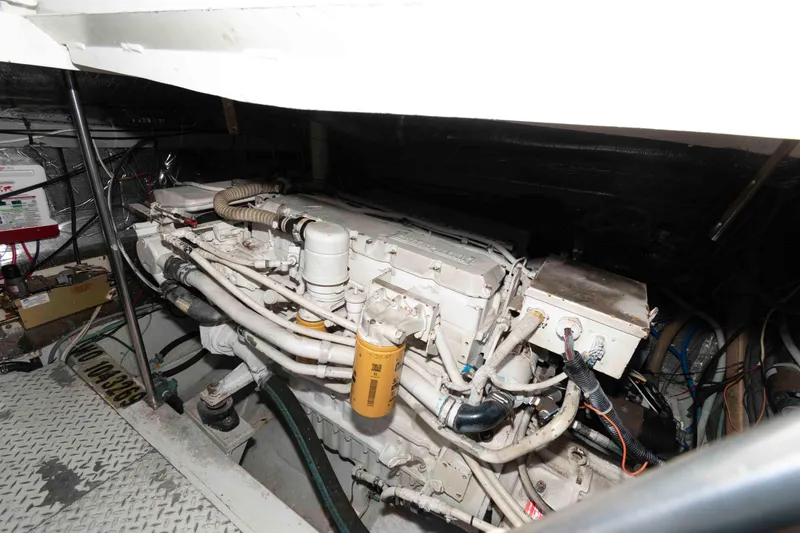 Slide: The Image of Engine room of a 1996 Trojan 440 Express Yacht, showcasing mechanical components. - 22