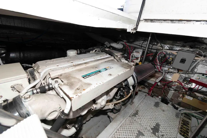 Slide: The Image of Engine room of a 1996 Trojan 440 Express Yacht, showcasing mechanical components. - 23