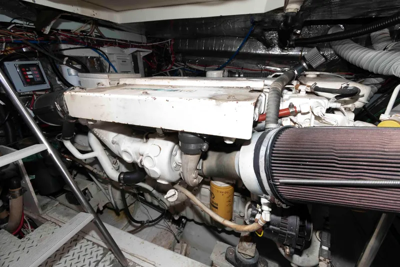 Slide: The Image of Engine room of a 1996 Trojan 440 Express Yacht, showcasing mechanical components. - 25