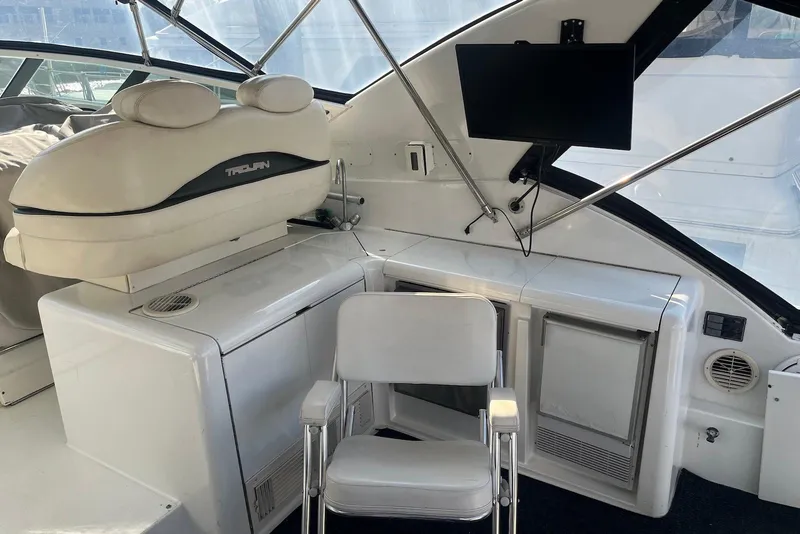Slide: The Image of 1996 Trojan 440 Express Yacht cockpit with dual seats and panoramic view. - 5
