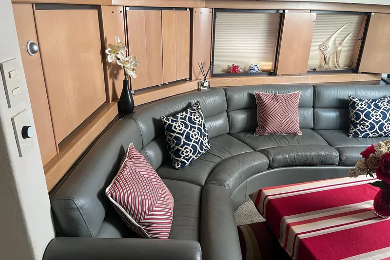 Slide: The Image of Luxurious interior of 1996 Trojan 440 Express Yacht with plush seating and cushions. - 9