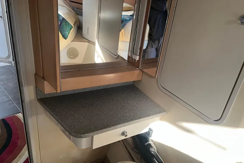 Slide: The Image of Interior of 1996 Trojan 440 Express Yacht with modern kitchen and cozy seating area. - 13