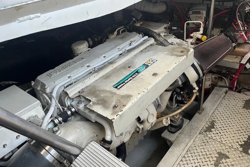 Slide: The Image of Luxurious interior of 1996 Trojan 440 Express Yacht with modern kitchen and cozy seating area. - 16