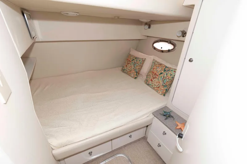 Slide: The Image of 1996 Trojan 440 Express Yacht cabin with cozy bed and decorative pillows. - 19