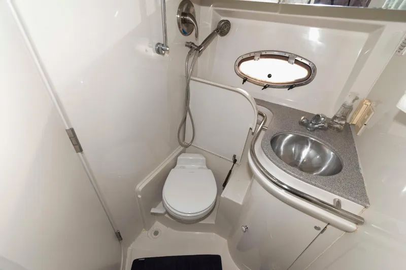 Slide: The Image of Compact bathroom in 1996 Trojan 440 Express Yacht with toilet, sink, and shower. - 20