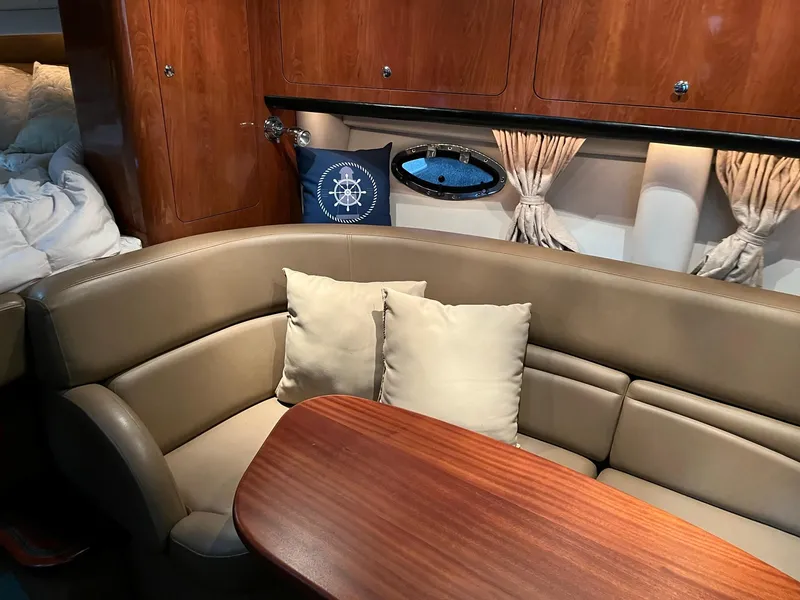 Slide: The Image of Interior of a 2011 Crownline 350 CR yacht with leather sofa and wooden table. - 17