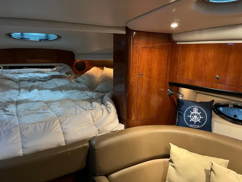 Slide: The Image of Interior of a 2011 Crownline 350 CR yacht with bed and seating area. - 19
