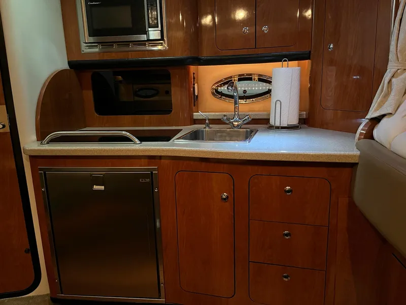 Slide: The Image of Galley kitchen in a 2011 Crownline 350 CR yacht. - 23