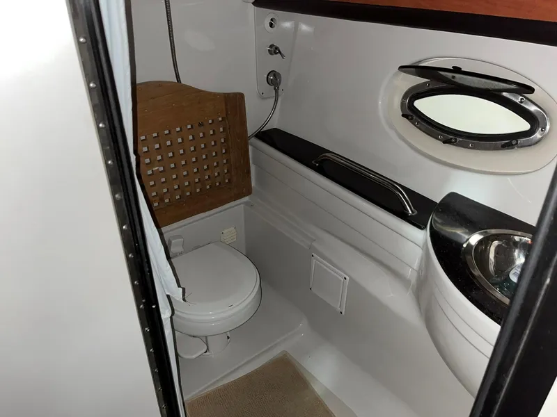 Slide: The Image of Interior of 2011 Crownline 350 CR with bathroom and sink. - 25