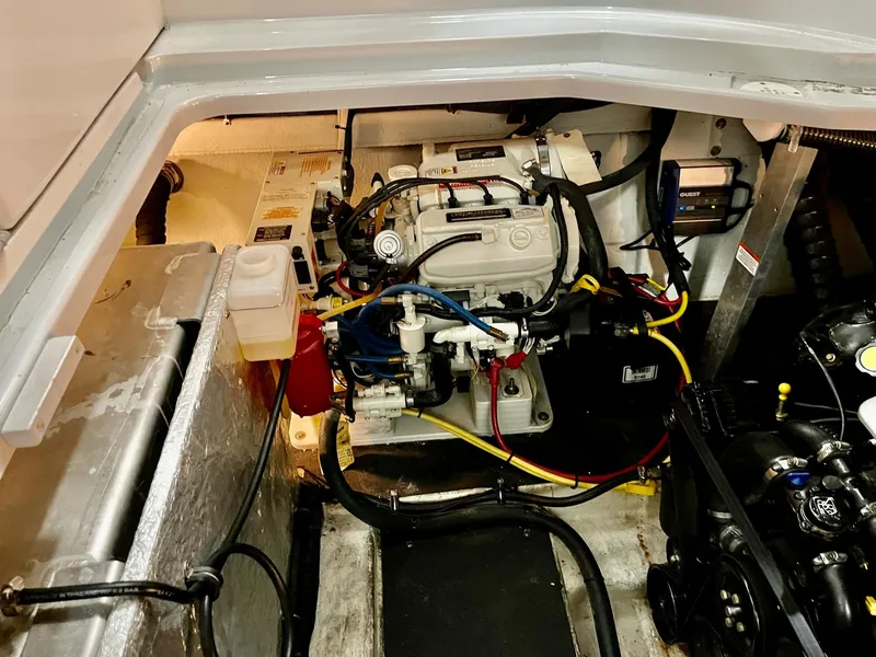 Slide: The Image of Engine compartment of 2011 Crownline 350 CR with visible cables and components. - 36