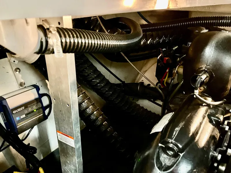 Slide: The Image of Engine compartment of a 2011 Crownline 350 CR boat with cables and hoses. - 39