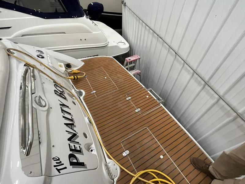 Slide: The Image of Crownline 350 CR 2011 with wooden deck in storage facility. - 5