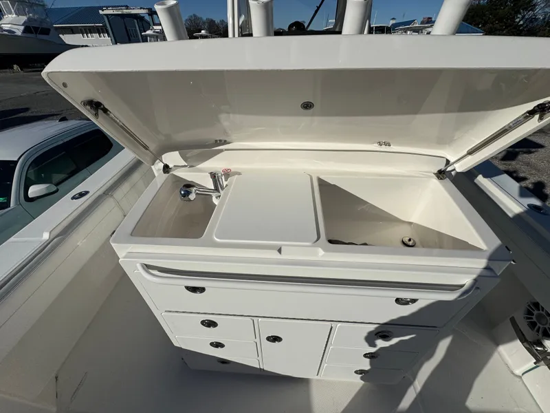 Slide: The Image of 2022 Regulator 31 boat with open storage and sink. - 23