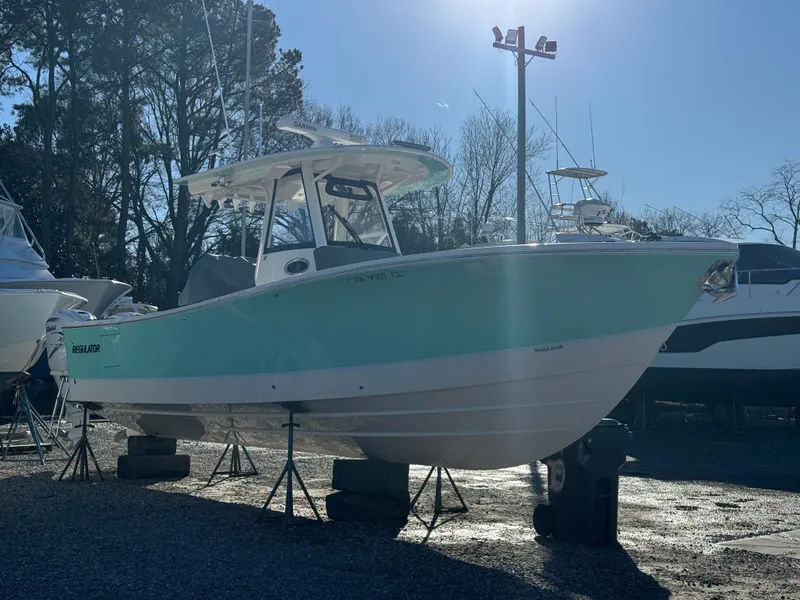 Slide: The Image of 2022 Regulator 31 boat on stands outdoors. - 26